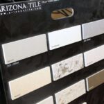 Arizona Tile sample display board showing small rectangular Della Terra Quartz swatches in light colors.