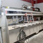 Large industrial Park Industries Pro-Edge IV stone edge shaping and polishing machine in a workshop.